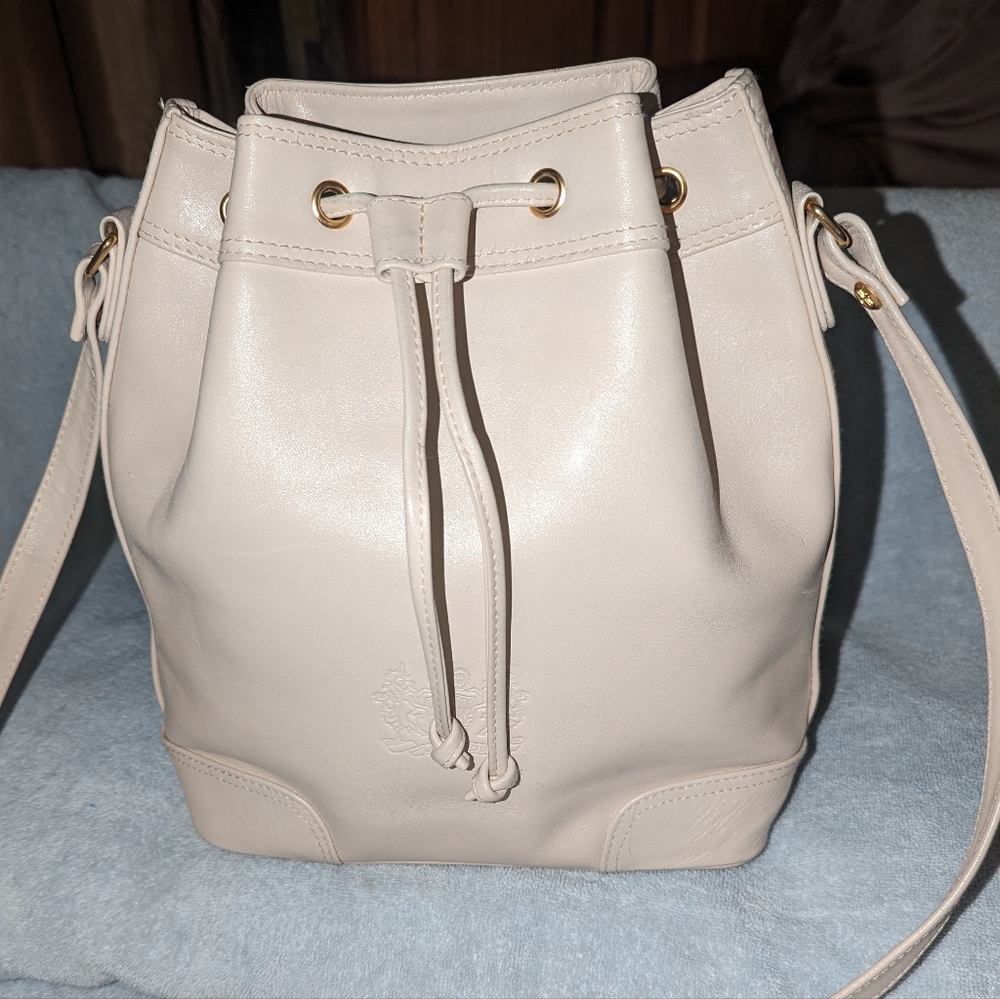 Louvier Paris cream leather drawstring shoulder bag.